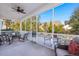 Relaxing screened porch with comfortable seating and ceiling fan at 3005 Aura Ln, Summerville, SC 29483