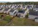 Aerial view of a home showing backyard, fencing, lawn and neighborhood with mature trees surrounding the community at 320 Silverleaf Ln, Moncks Corner, SC 29461
