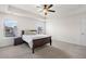 Bedroom with tray ceiling, ceiling fan, carpet flooring, and natural light from two windows at 320 Silverleaf Ln, Moncks Corner, SC 29461
