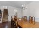 Spacious dining room with a chandelier and natural light near the stairway at 320 Silverleaf Ln, Moncks Corner, SC 29461