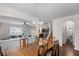 Open dining room with chandelier, seamlessly connected to the living area at 320 Silverleaf Ln, Moncks Corner, SC 29461