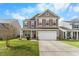 Charming two-story home featuring a two-car garage and beautifully landscaped front yard at 320 Silverleaf Ln, Moncks Corner, SC 29461