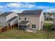 Back of home featuring solar panels and a screened in porch at 320 Silverleaf Ln, Moncks Corner, SC 29461