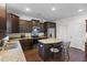 An inviting kitchen with granite countertops, stainless steel appliances and dark wood cabinetry at 320 Silverleaf Ln, Moncks Corner, SC 29461