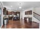 Bright kitchen featuring dark wood cabinets, granite countertops, stainless steel appliances, and a center island at 320 Silverleaf Ln, Moncks Corner, SC 29461