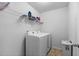 Efficient laundry room with modern washer and dryer, wire shelving, and ample space for cleaning supplies and storage at 320 Silverleaf Ln, Moncks Corner, SC 29461