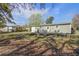 Spacious backyard with a covered patio and ample seating, ideal for relaxation and entertaining amidst lush greenery at 322 Lantana Dr, Charleston, SC 29407