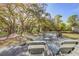 Spacious backyard with a patio, seating, and mature trees providing shade at 322 Lantana Dr, Charleston, SC 29407