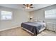 Cozy bedroom with a ceiling fan, natural light from two windows, and neutral paint, offering a relaxing space at 322 Lantana Dr, Charleston, SC 29407