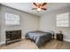 A modern bedroom with light wood floors, fan, natural lighting, and dresser for easy storage at 322 Lantana Dr, Charleston, SC 29407