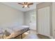 A simple bedroom with a modern ceiling fan, neutral tones, and a door to the backyard, offering easy outdoor access at 322 Lantana Dr, Charleston, SC 29407