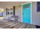 Welcoming front porch with a turquoise door, bench, and black shutters at 322 Lantana Dr, Charleston, SC 29407
