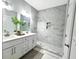 Bright bathroom showcasing double vanity, contemporary lighting, marble shower with glass door and plant for decor at 3292 N Highway 52, Saint Stephen, SC 29479