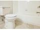 Bright bathroom showing a white toilet and a bathtub featuring chrome faucet and fittings, along with marble-look floor tiles at 3292 N Highway 52, Saint Stephen, SC 29479