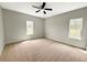 Spacious bedroom featuring carpeted floors, neutral walls, ceiling fan, and natural light from two windows at 3292 N Highway 52, Saint Stephen, SC 29479