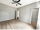 Spacious carpeted bedroom with neutral walls, featuring 3 door openings and a ceiling fan with lights at 3292 N Highway 52, Saint Stephen, SC 29479
