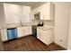 Bright kitchen with white cabinets, stainless steel appliances, hardwood floors, and gray marble countertops at 3292 N Highway 52, Saint Stephen, SC 29479