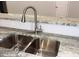 New kitchen stainless steel faucet sitting on a gray marble countertop, and hardwood floors at 3292 N Highway 52, Saint Stephen, SC 29479