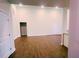 An open-concept living room featuring hardwood floors, white walls, recessed lighting, and an entry to another room at 3292 N Highway 52, Saint Stephen, SC 29479