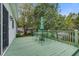 Inviting back deck with green painted wood, outdoor furniture and umbrella, perfect for relaxation and entertaining at 3378 Von Ohsen Rd, Ladson, SC 29485