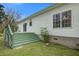 Back deck with green railing, access stairs to yard, and exterior access to the home at 3378 Von Ohsen Rd, Ladson, SC 29485
