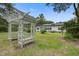 Spacious backyard with lush greenery, a wooden pergola, and a charming view of the house at 3378 Von Ohsen Rd, Ladson, SC 29485