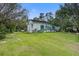 Spacious backyard featuring a green deck, lush lawn, mature trees, and ample room for outdoor activities at 3378 Von Ohsen Rd, Ladson, SC 29485