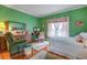 Bright and cozy bedroom with floral accents, hardwood floors, and comfortable furnishings at 3378 Von Ohsen Rd, Ladson, SC 29485
