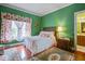 Inviting bedroom with bright green walls, hardwood floors, and comfortable furnishings at 3378 Von Ohsen Rd, Ladson, SC 29485