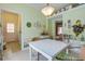 Cozy dining area with a white wicker table set, light green walls, and decorative wall accents at 3378 Von Ohsen Rd, Ladson, SC 29485