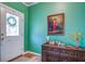 Foyer with wood flooring, accent color wall, statement art, and patterned rug at 3378 Von Ohsen Rd, Ladson, SC 29485