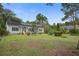 Well-maintained home with green shutters and solar panels in a large front yard with mature trees at 3378 Von Ohsen Rd, Ladson, SC 29485