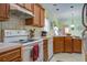 Well-lit kitchen showcasing light wood cabinets, white appliances, and decorative tile backsplash at 3378 Von Ohsen Rd, Ladson, SC 29485