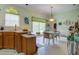 Bright eat-in kitchen featuring wood cabinets, tile floors, a dining table, and a sliding glass door to the outside at 3378 Von Ohsen Rd, Ladson, SC 29485