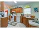 Traditional kitchen with wooden cabinets, white appliances, decorative accents, and natural light from an arched window at 3378 Von Ohsen Rd, Ladson, SC 29485