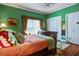 Cozy bedroom featuring hardwood floors, comfortable bedding, and ample closet space at 3378 Von Ohsen Rd, Ladson, SC 29485