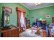 Green home office featuring a desk, chair, shelving, and a window with custom curtains at 3378 Von Ohsen Rd, Ladson, SC 29485