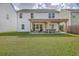 Backyard view featuring a well-manicured lawn and covered patio with an outdoor seating area and firepit at 353 Dunlin Dr, Summerville, SC 29486
