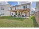Lovely backyard with a lush lawn and a patio featuring an outdoor seating area and a firepit at 353 Dunlin Dr, Summerville, SC 29486