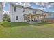 Spacious backyard with a well-maintained lawn and covered patio with an outdoor seating and firepit at 353 Dunlin Dr, Summerville, SC 29486
