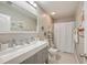 Bright bathroom with neutral tones, decorative ladder shelving, and a large mirror above the vanity at 353 Dunlin Dr, Summerville, SC 29486