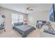 Cozy bedroom with ceiling fan, natural light, and a dedicated workspace with a monitor and neutral colors at 353 Dunlin Dr, Summerville, SC 29486