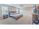 Well-lit bedroom showcasing a comfortable king-size bed, ceiling fan, and window views at 353 Dunlin Dr, Summerville, SC 29486