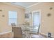 Cozy dining area features a glass table, modern chairs, and a door leading outside at 353 Dunlin Dr, Summerville, SC 29486
