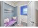 Entryway with storage bench, hooks, and a view into a colorful half bathroom at 353 Dunlin Dr, Summerville, SC 29486