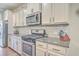 Modern kitchen with stainless steel appliances, granite countertops, and white cabinets at 353 Dunlin Dr, Summerville, SC 29486