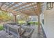 Inviting outdoor patio featuring a pergola, comfortable seating, and a fire pit perfect for entertaining at 353 Dunlin Dr, Summerville, SC 29486