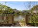 Lush backyard with wooden fence and serene water views at 3558 Stockton Dr, Mount Pleasant, SC 29466