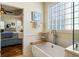 Bright bathroom features a soaking tub with views into the main bedroom at 3558 Stockton Dr, Mount Pleasant, SC 29466