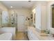 Elegant bathroom features a glass enclosed shower, soaking tub, and double vanity with white cabinetry at 3558 Stockton Dr, Mount Pleasant, SC 29466